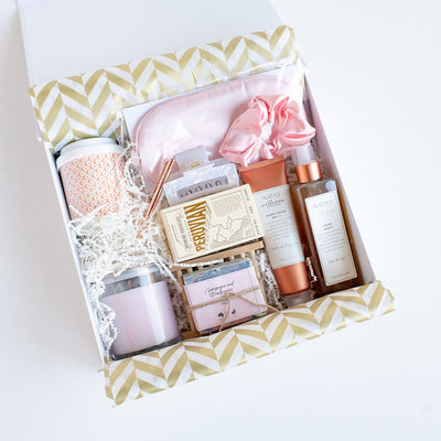 Luxury Gift hamper box with skincare products, a face mask, and other items on a white background
