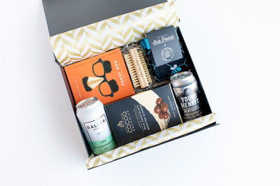 Gift box with a man or dad with various items including a can of beer, a book, and other products 